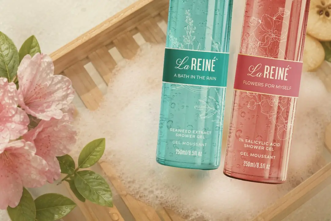 Both shower gels on a bamboo bath tray over foam